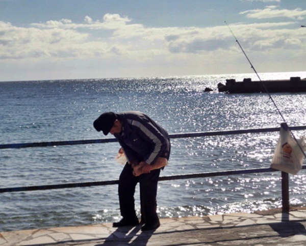 Un pêcheur vient de s’installer devant moi. Le bonnet de travers et la ligne pleine de nœuds.   Le léger tremblement de ses membres, sans doute inversement proportionnel avec la puissance du raki local, rend la pose des mini plombs et de l’hameçon aussi périlleuse que problématique...