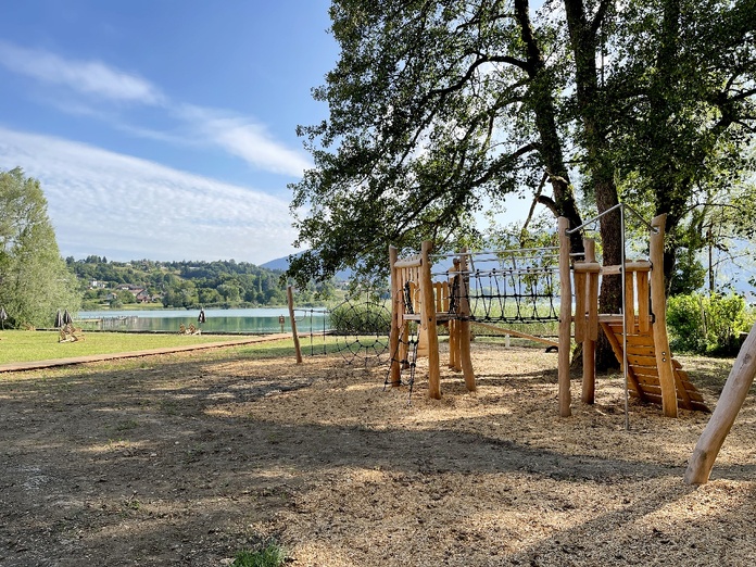 Les jeux pour enfants situés dans un espace ombragé - Photo Huttopia
