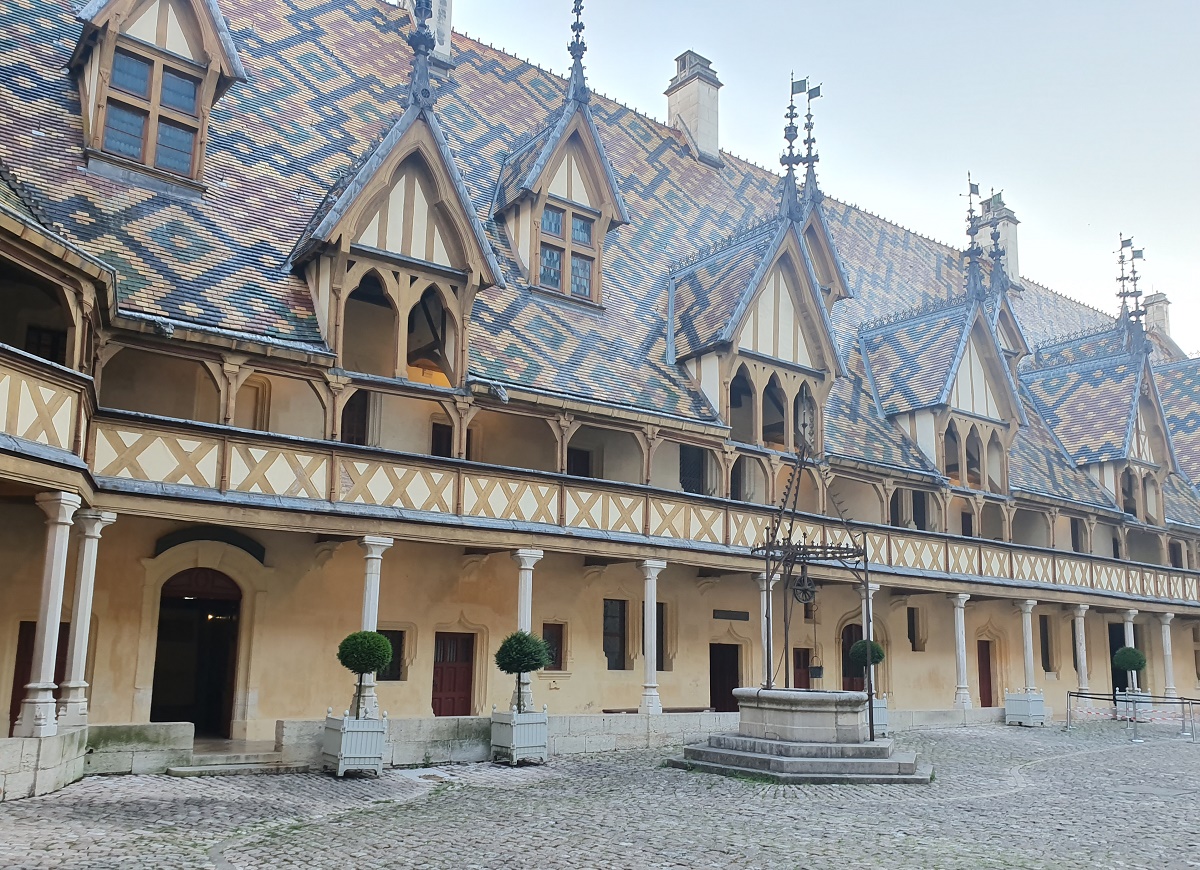 La cour d’honneur de l’hôtel Dieu, face aux bâtiments couverts de tuiles multicolores émaillées, ébauchant des formes géométriques ornées de girouettes - DR : J.-P.C.